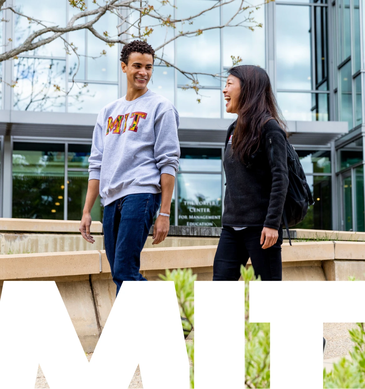 People walking on campus, wearing MIT apparel