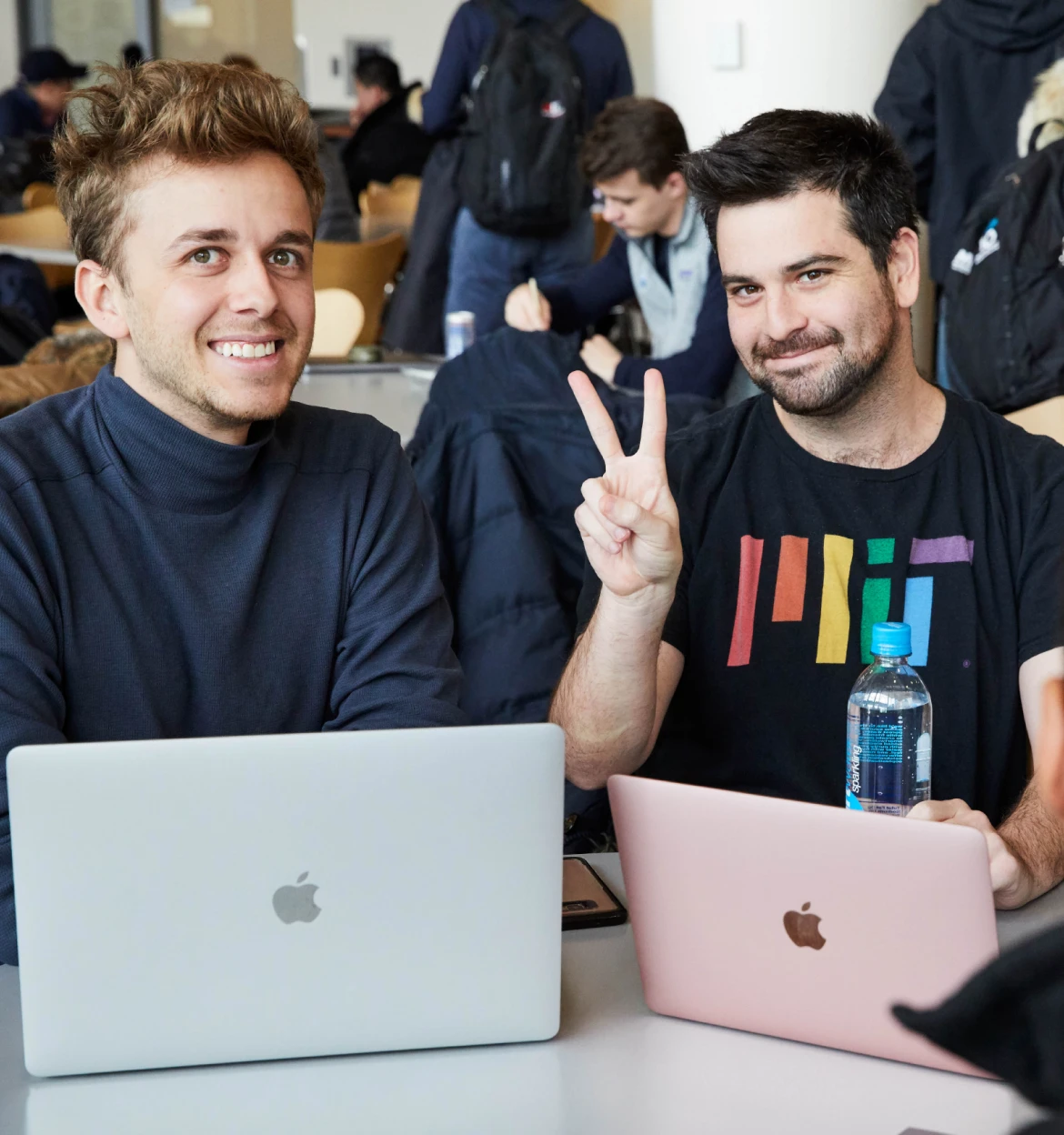 MIT Sloan people with laptops posing for picture